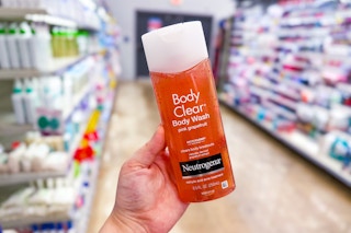 person holding a bottle of neutrogena body wash in an aisle