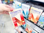 hand holding a box of Nicorette gum