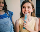 a little kid with a popsicle 