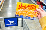 hand holding a box of velveeta shells and cheese
