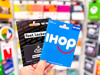 hand holding one Foot Locker and one IHOP gift card