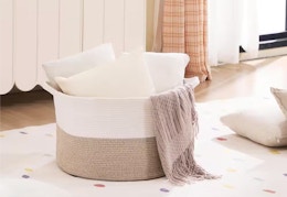 large rope basket with throw pillows sitting inside