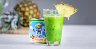 pediasure grow and gain vanilla next to green monster smoothie with pineapple wedge