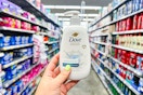 hand holding a bottle of dove-hand-wash in walmart aisle