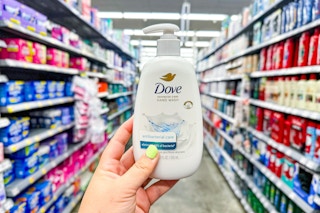 person holding dove hand wash in an aisle