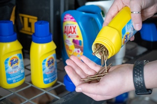 Reuse a laundry detergent bottle for tool shed storage.
