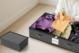 a woman putting clothes in a storage container