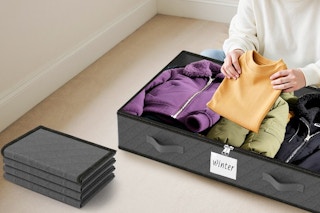 a woman putting clothes in a storage container