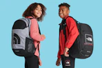 A young girl and boy each wear The North Face Sunder Backpack