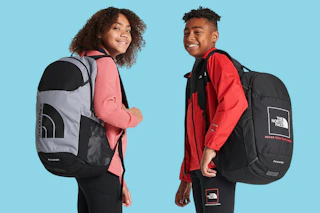 A young girl and boy each wear The North Face Sunder Backpack