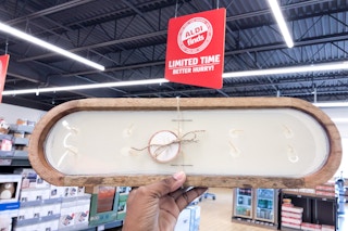 aldi 10 wick candle handheld near an aldi sign