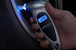 a tire pressure gauge on a tire