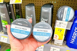 person holding 2 dove men+care hair pastes