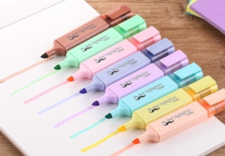 highlighters lined up on paper