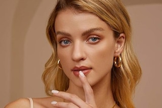 a woman wearing gold earrings