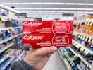 hand holding colgate toothpastes in walgreens