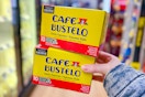 hand holding cafe bustelo coffee pod boxes