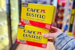 hand holding cafe bustelo coffee pod boxes
