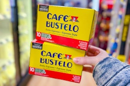 hand holding cafe bustelo coffee pod boxes