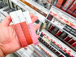 3 Maybelline lip products held in hand 