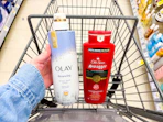 hand holding olay and old spice body wash in walgreens