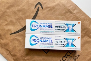 tubes of sensodyne toothpaste over an amazon package
