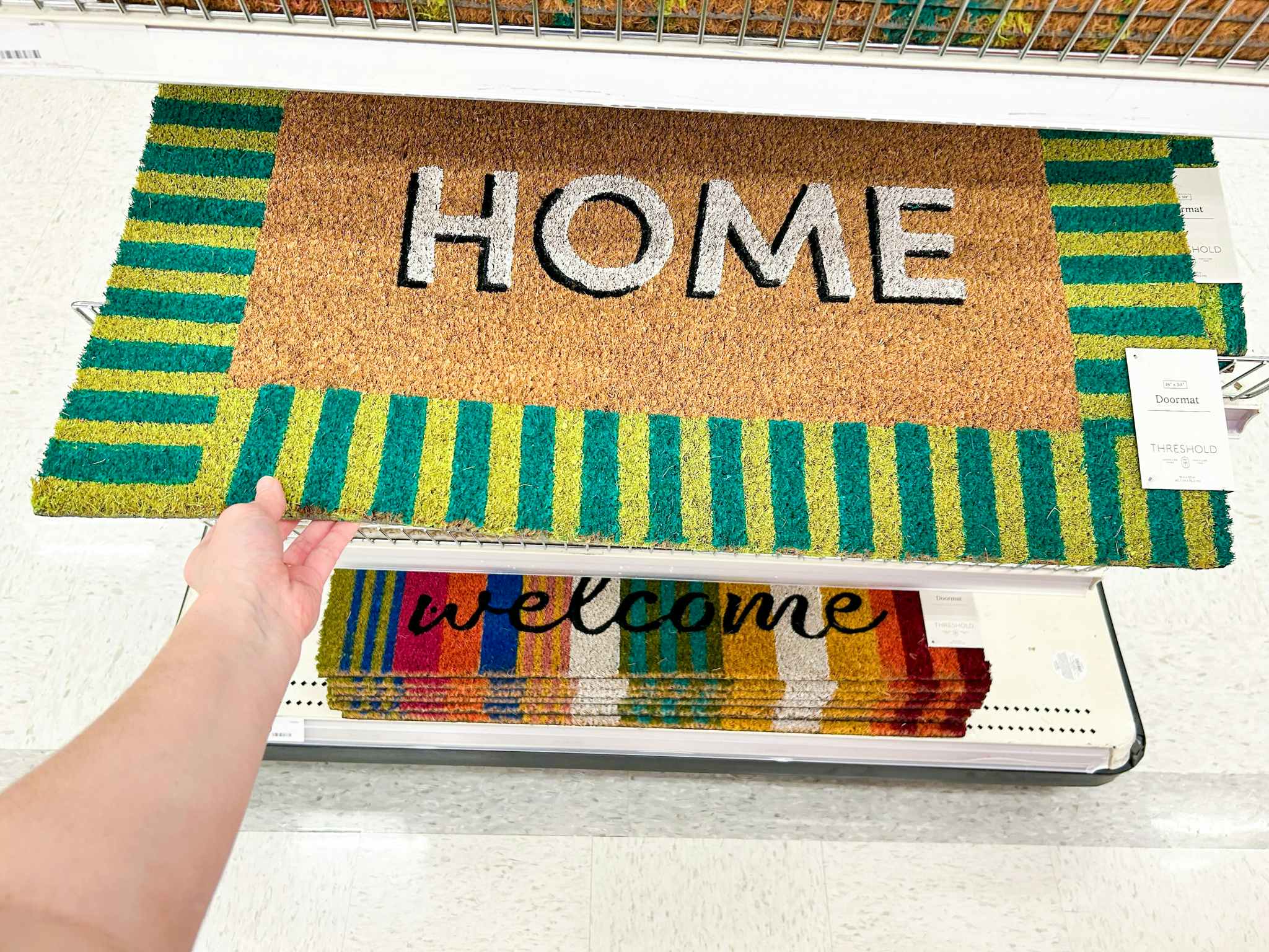 hand holding home summer doormat at target