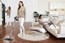 a person cleaning a room with a steam mop