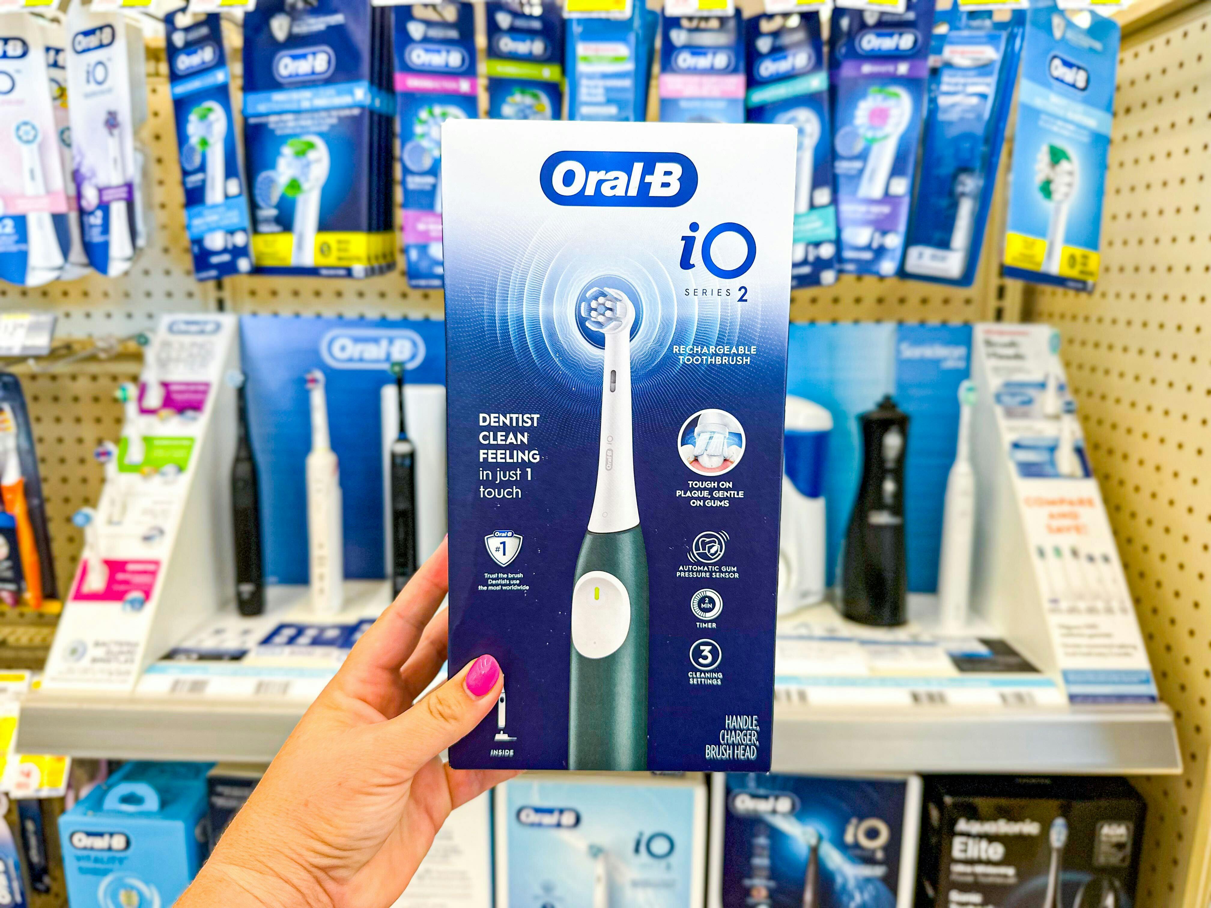 hand holding oral b electric toothbrush in walgreens
