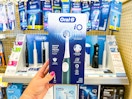 hand holding oral-b io2 electric toothbrush