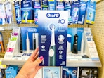 hand holding oral b electric toothbrush in walgreens