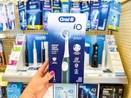 hand holding oral-b io2 electric toothbrush