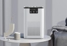white air purifier sitting on a side table