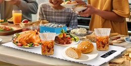 a family sitting at a table with food on a warming mat