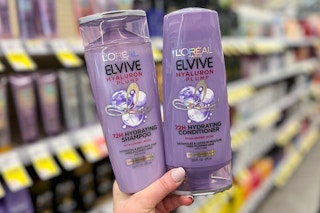 hand holding 2 l'oreal elvive shampoo and conditioner