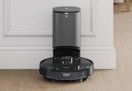 black robot vacuum and mop with self-emptying station
