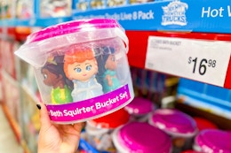 hand holding a disney bath set bucket