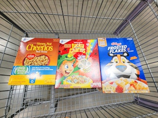 a cart with 2-packs of honey nut cheerios, lucky charms, and frosted flakes