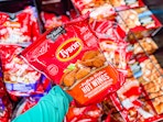 hand holding a bag of tyson anytizers wings at walmart