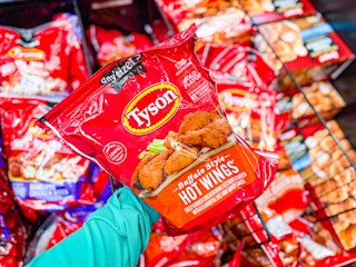 hand holding a bag of tyson anytizers wings at walmart