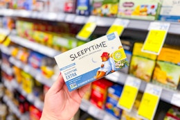 person holding a box of tea