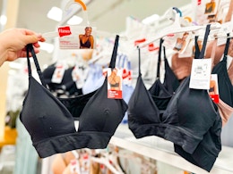 hand holding a hanes women's longline bra in front of a bra