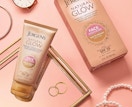a tube of lotion next to it's packing on a pink surface