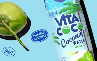 Coconut water bottle on a blue background with a coconut