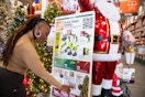 a woman looking at the black friday ad display at Home Depot