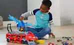 a kid playing with a hot wheels toy