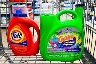 large bottles of tide and gain laundry detergent in a shopping cart