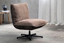 Lifestyle image of a modern chenille swivel chair in home setting