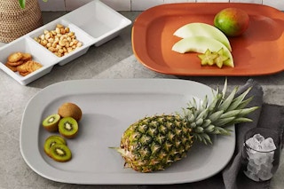 lifestyle image of a 3-piece servewear set with food on it