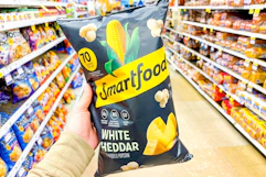 hand holding a bag of smartfood popcorn